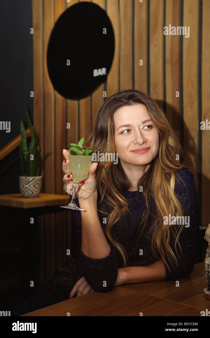Pretty girl drinking cocktail in bar Stock Photo Alamy