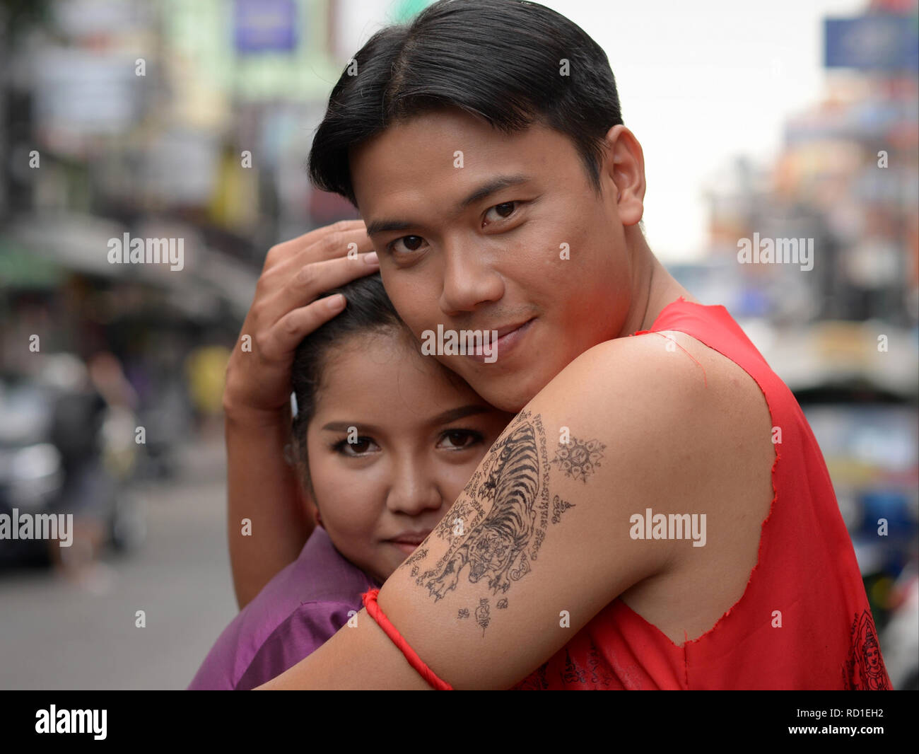Young Thai couple locked in a tender embrace. Stock Photo