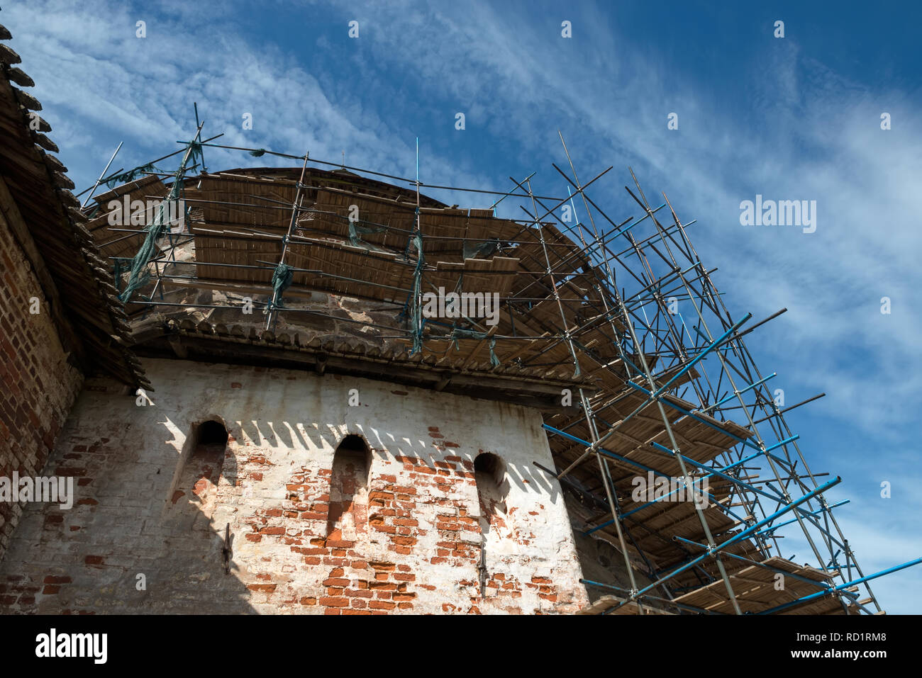 Scaffolding on a renovated old fortress tower Stock Photo