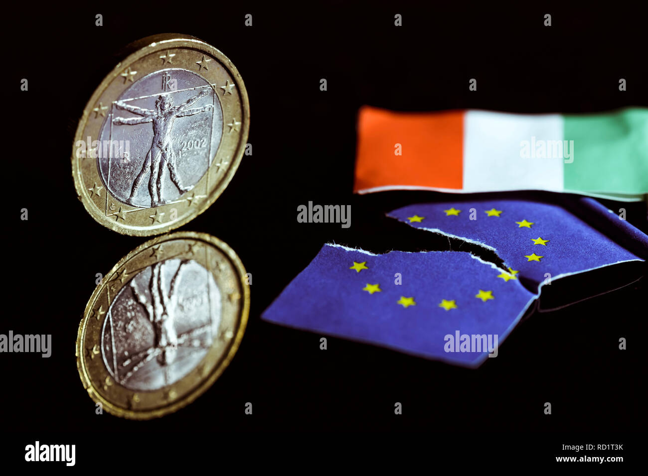 Italian eurocoin and torn EU flag, symbolic photo debt crisis in Italy, Italienische Euromünze und zerrissene EU-Fahne, Symbolfoto Schuldenkrise in It Stock Photo