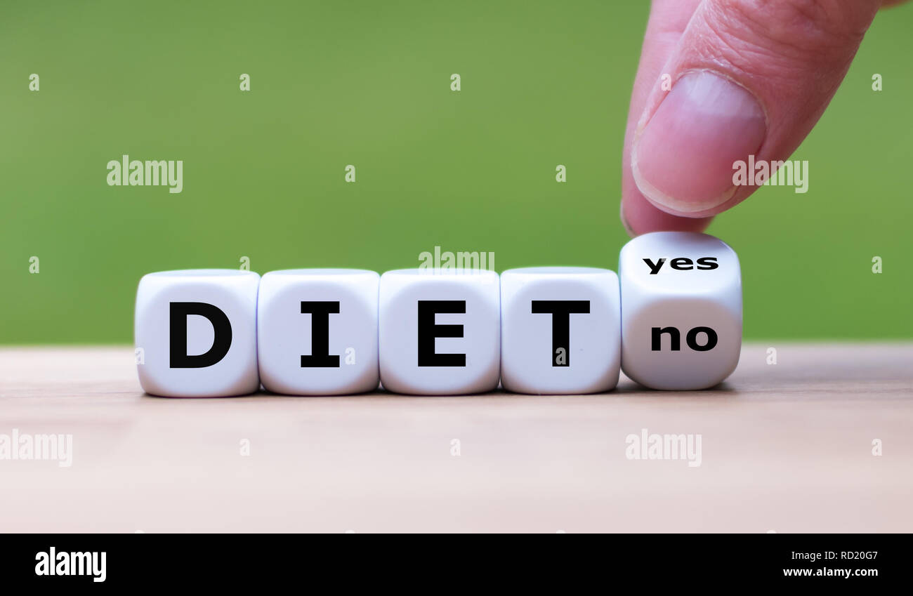 Starting with a diet. Hand is turning a dice and changes the word "no" to "yes! Stock Photo