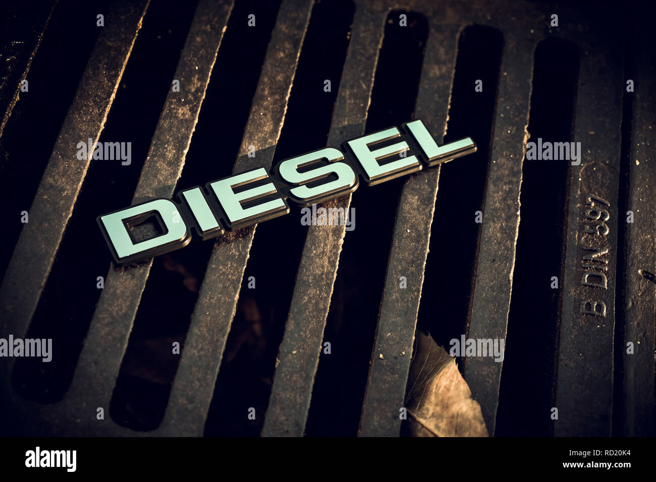 Diesel signs on a Gullideckel, end of the diesel car, Diesel-Zeichen auf einem Gullideckel, Ende des Diesel-Autos Stock Photo
