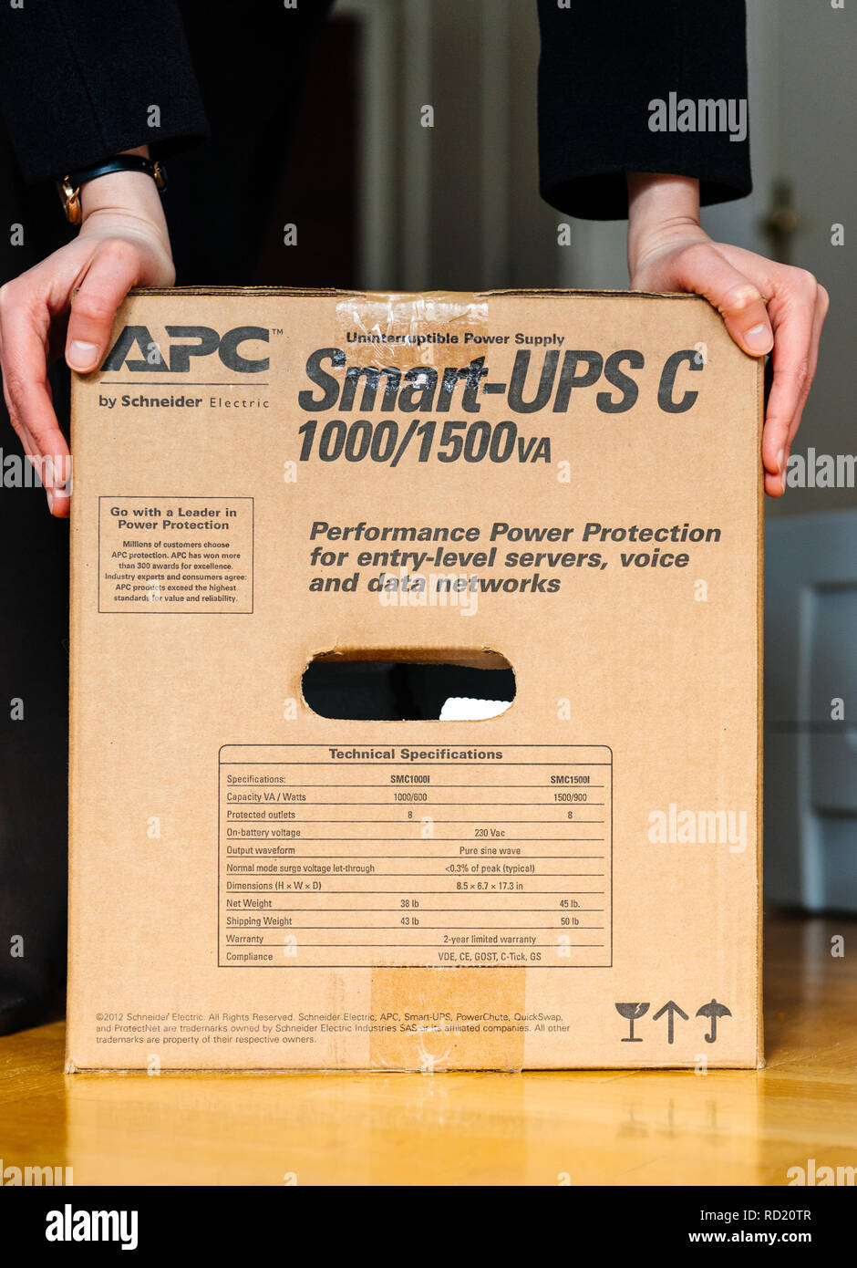 PARIS, FRANCE - MAR 29, 2018: IT woman unboxing APC Smart-UPS C 1000VA LCD  230V enterprise-level uninterruptible power supplies made by American Power  Conversion office wooden floor Stock Photo - Alamy