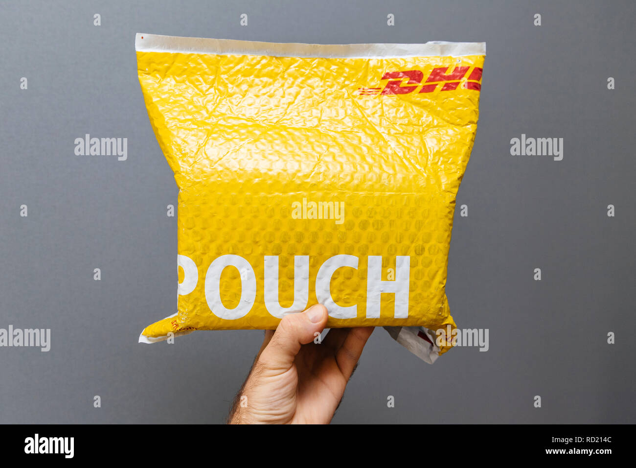 PARIS, FRANCE - MAR 24, 2018: Male point of view and the hand with DHL ...