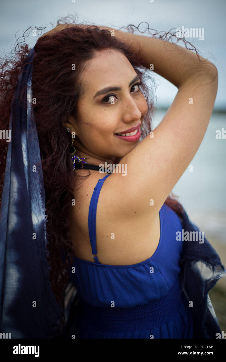 Smiling woman with her hand in her hair Stock Photo
