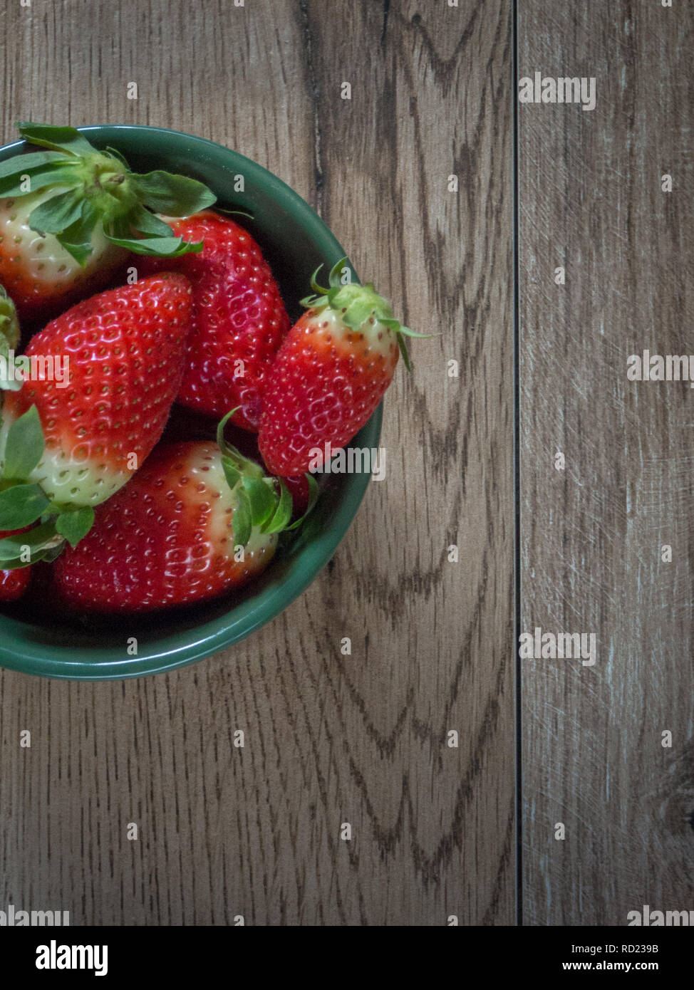Strawberries on wood background with copy space Stock Photo - Alamy