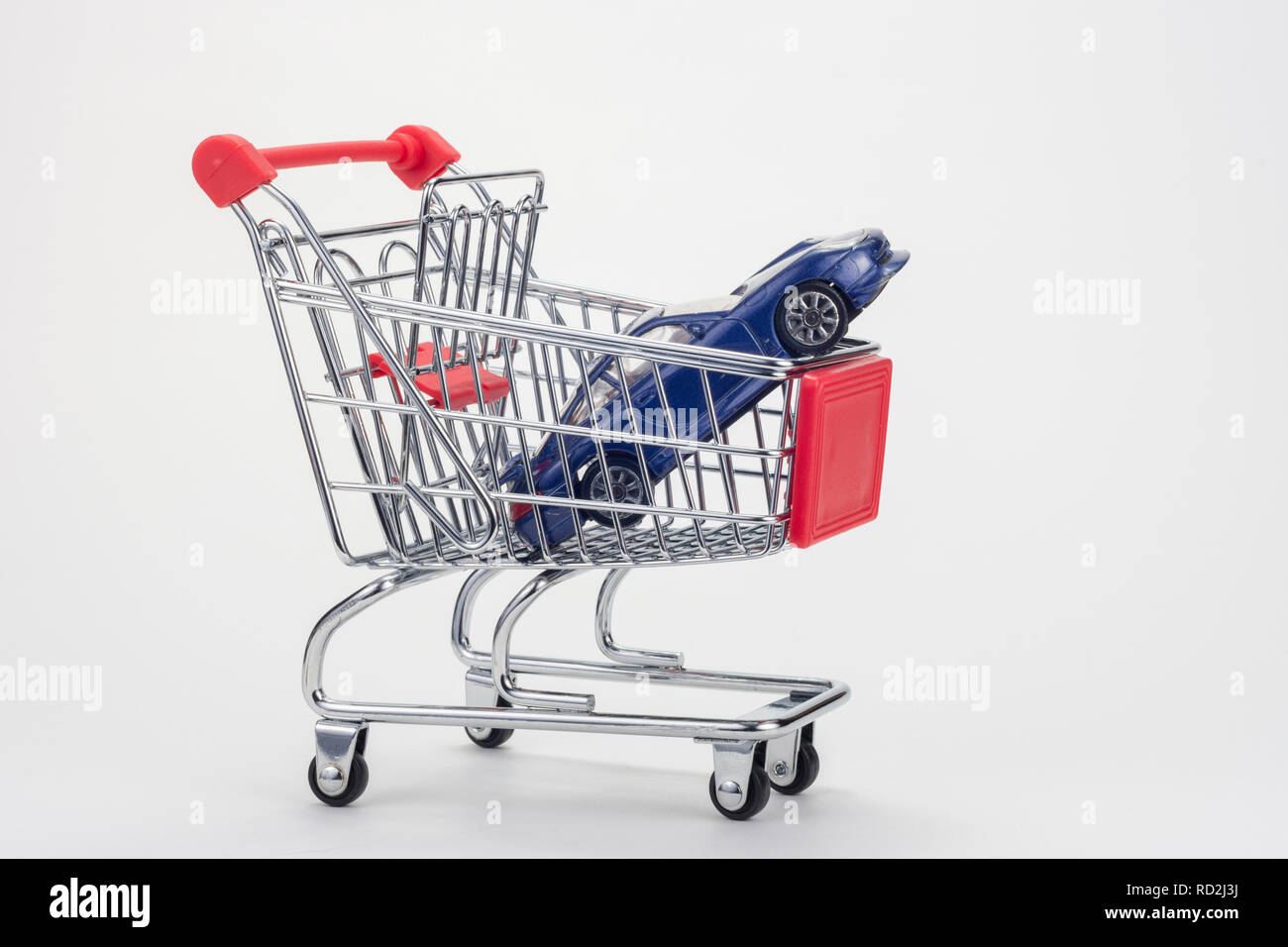 In the grocery cart is a car Stock Photo Alamy