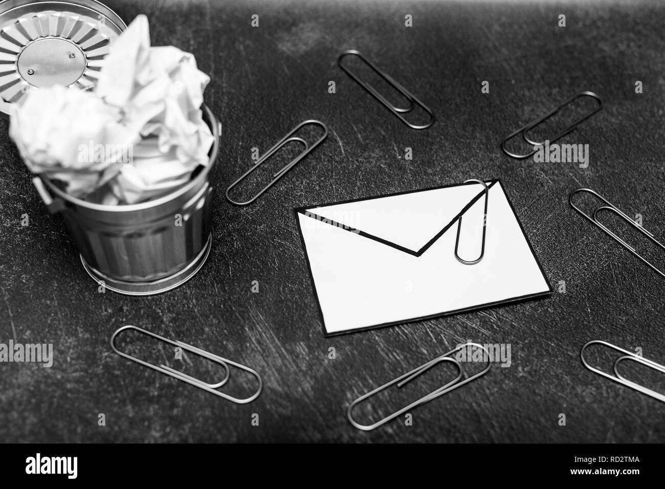 envelope with clip symbol of email and attachments with trash can next to it, concept of spam and unwanted emails Stock Photo