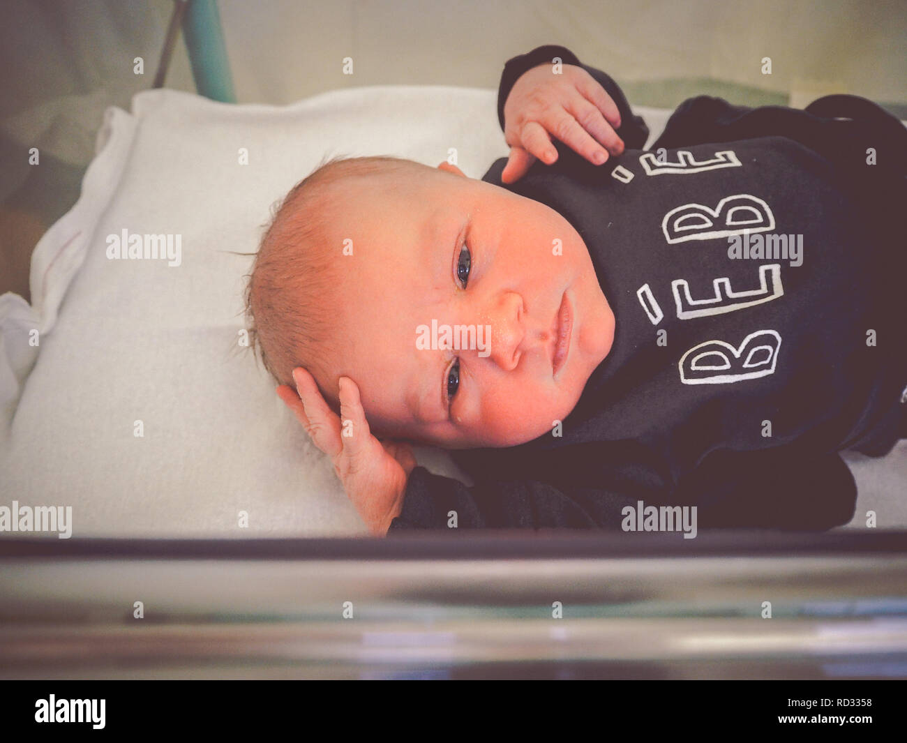 Newborn baby boy in hospital crib Stock Photo