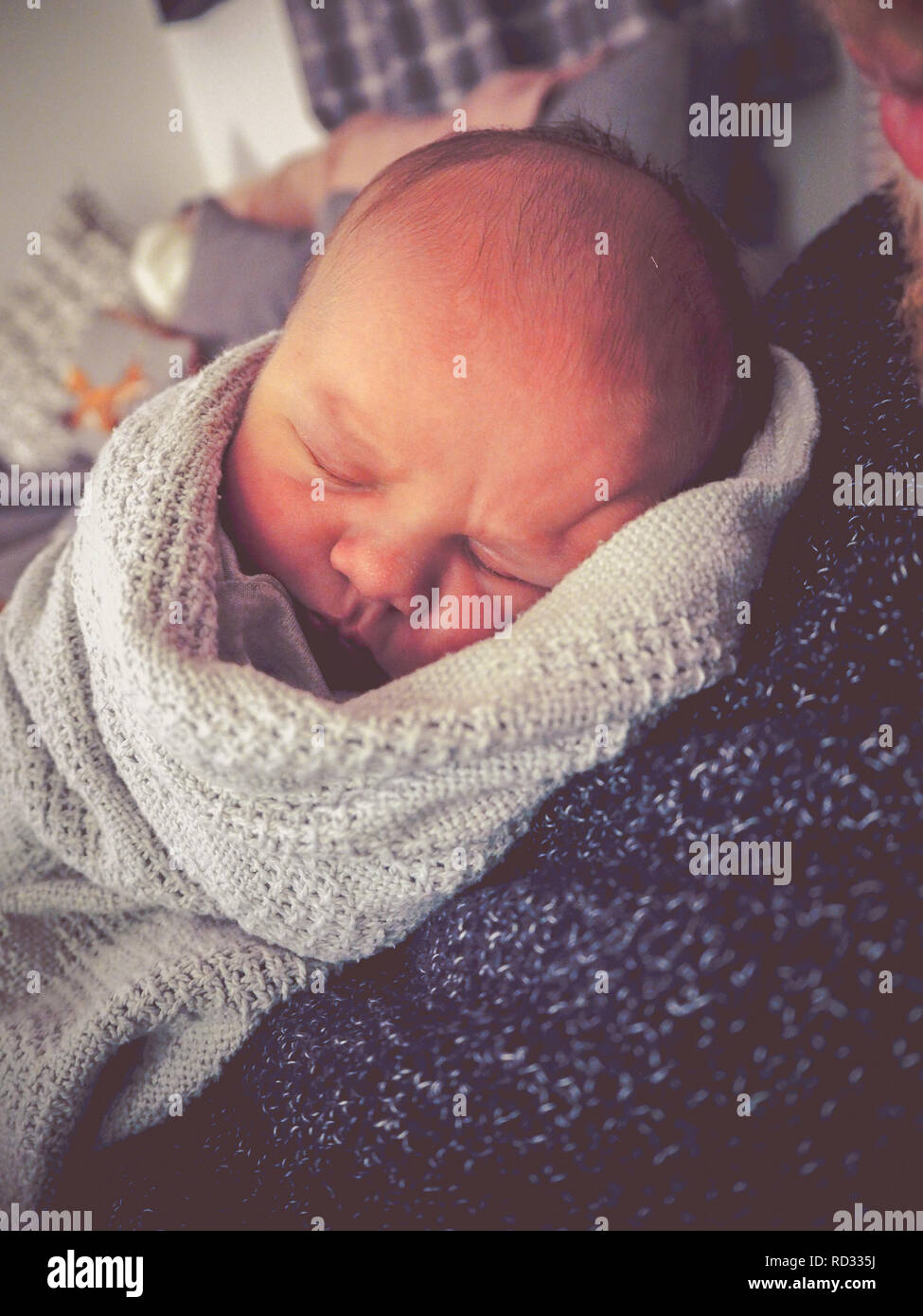 Newborn baby boy cuddling father Stock Photo