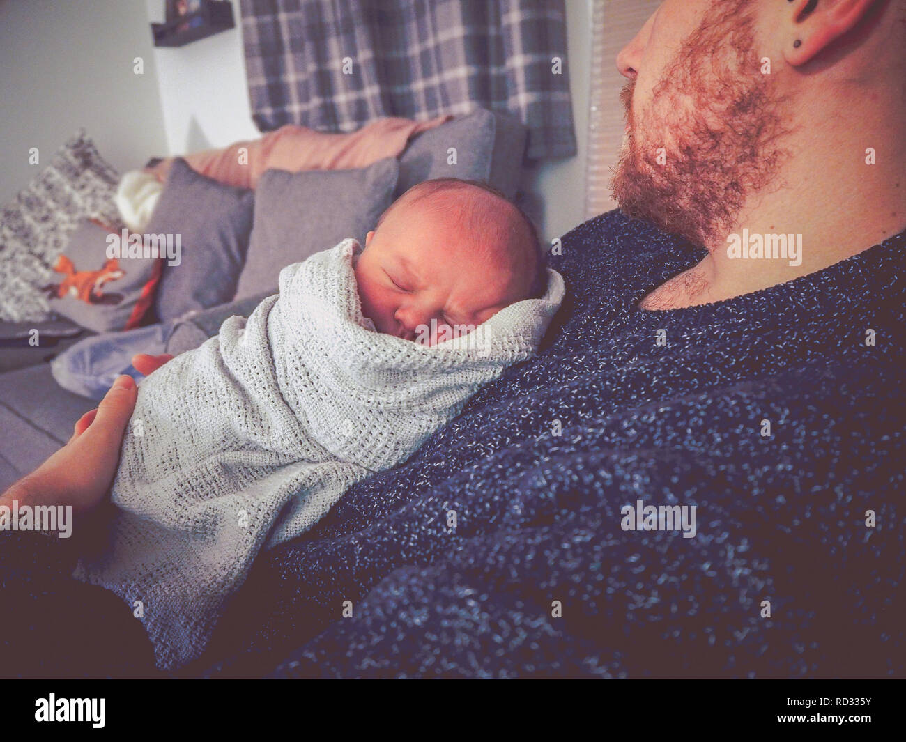 Newborn baby boy cuddling father Stock Photo