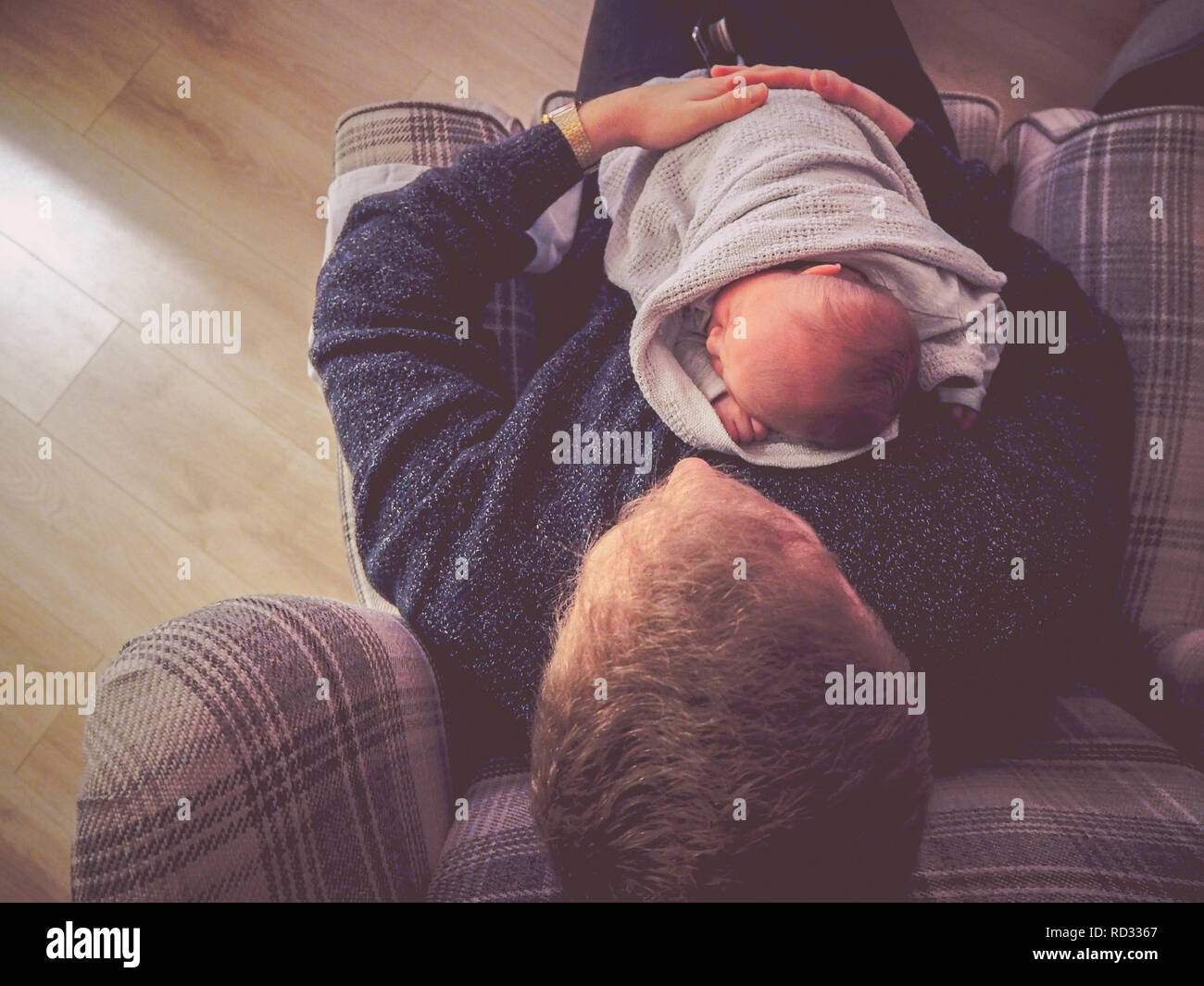 Newborn baby boy cuddling father Stock Photo