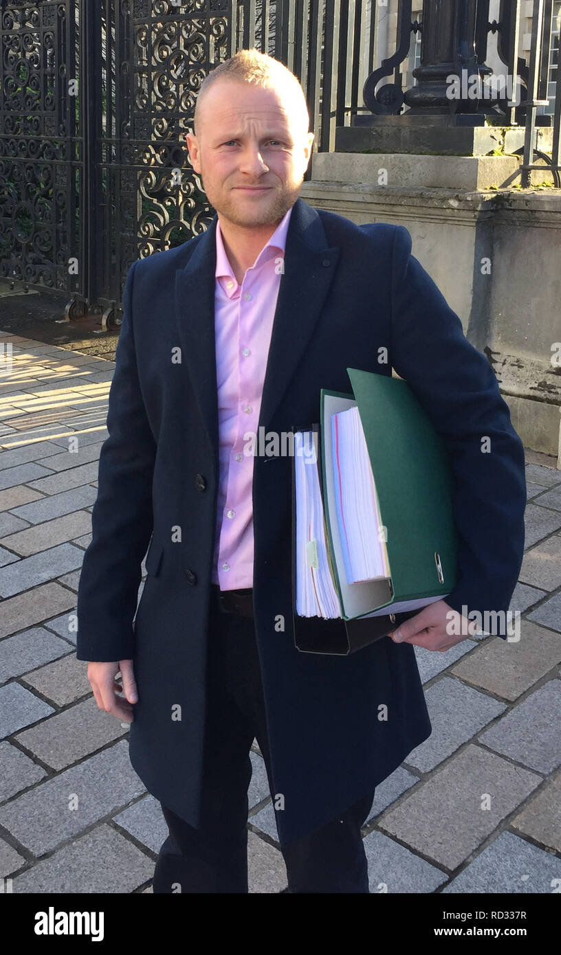 Loyalist activist Jamie Bryson outside the High Court in Belfast as he has launched a High Court challenge against the legality of warrants used to search his premises. Stock Photo