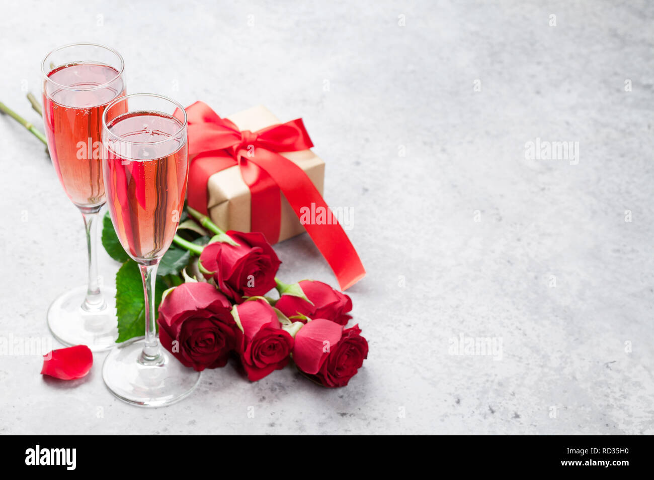 Valentine's day greeting card with champagne, gift box and rose flowers ...