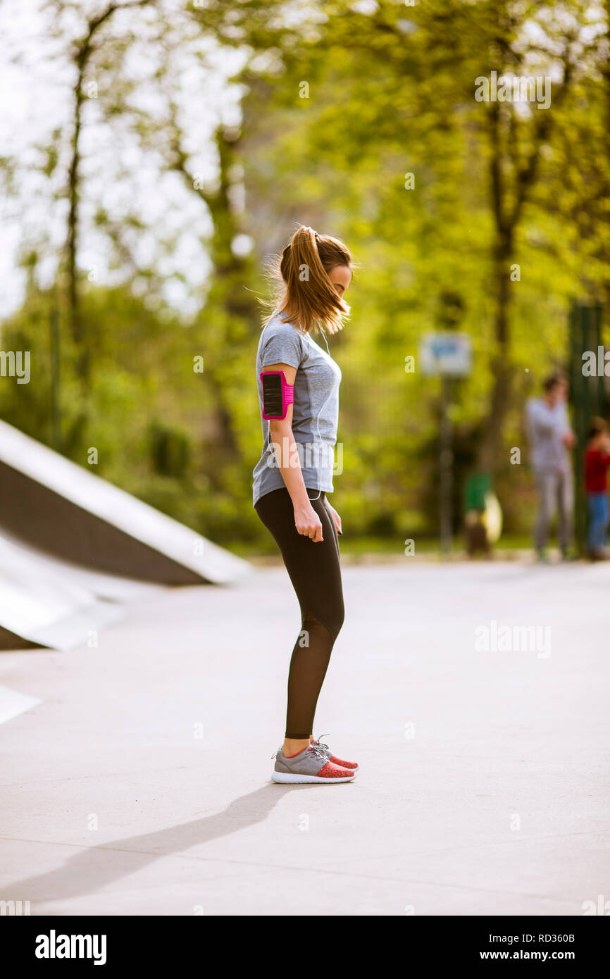 Pretty young woman having exercise in the park on a sunny day Stock ...