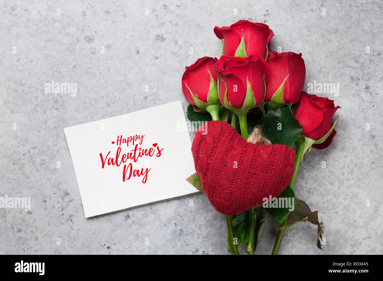 Valentine's day greeting card with red rose flowers bouquet on stone ...