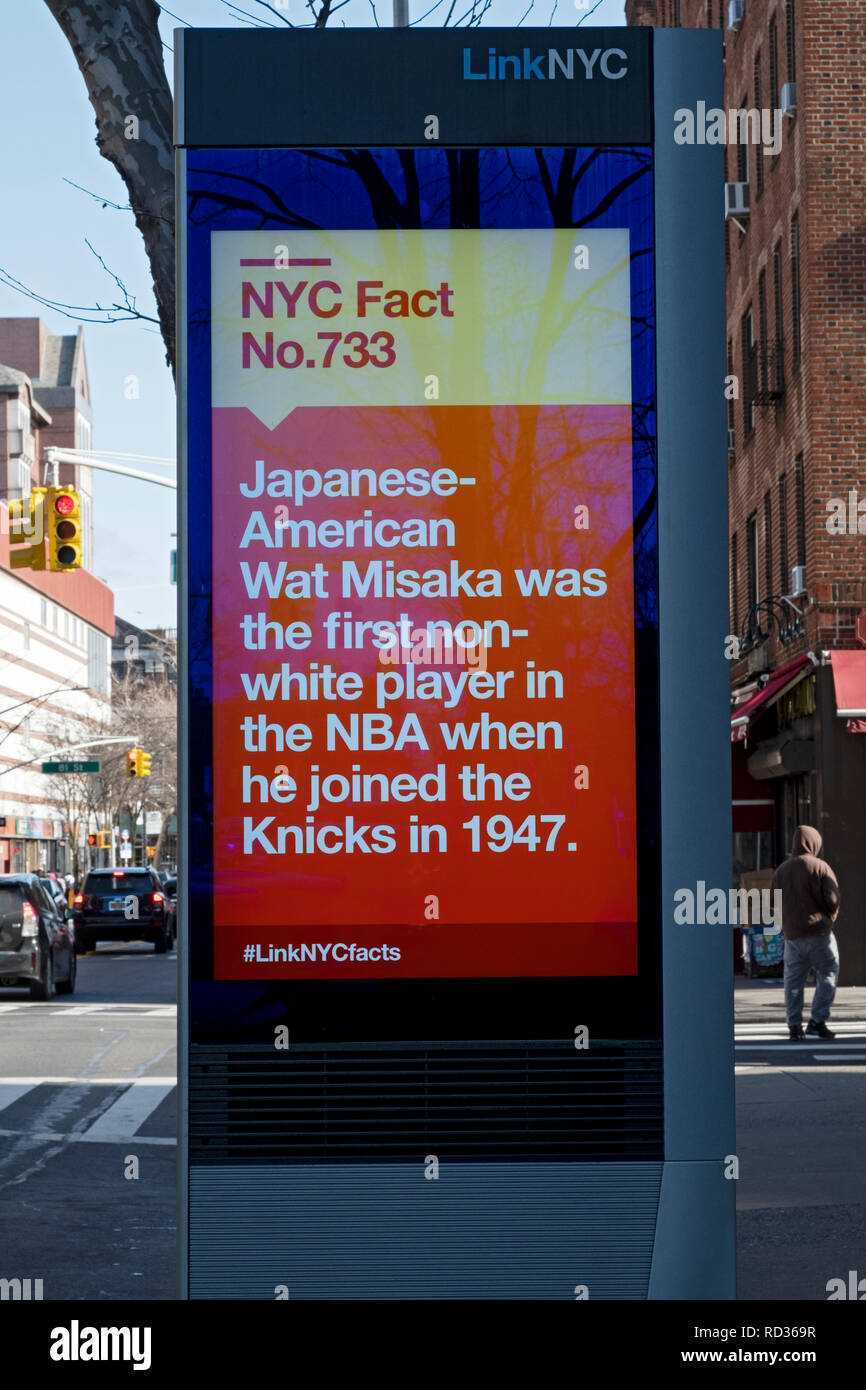 A message on a LINK NYC screen with the fun fact that the first non-white player in the NBA was Japanese American Wat Misaka. In Queens, NYC Stock Photo