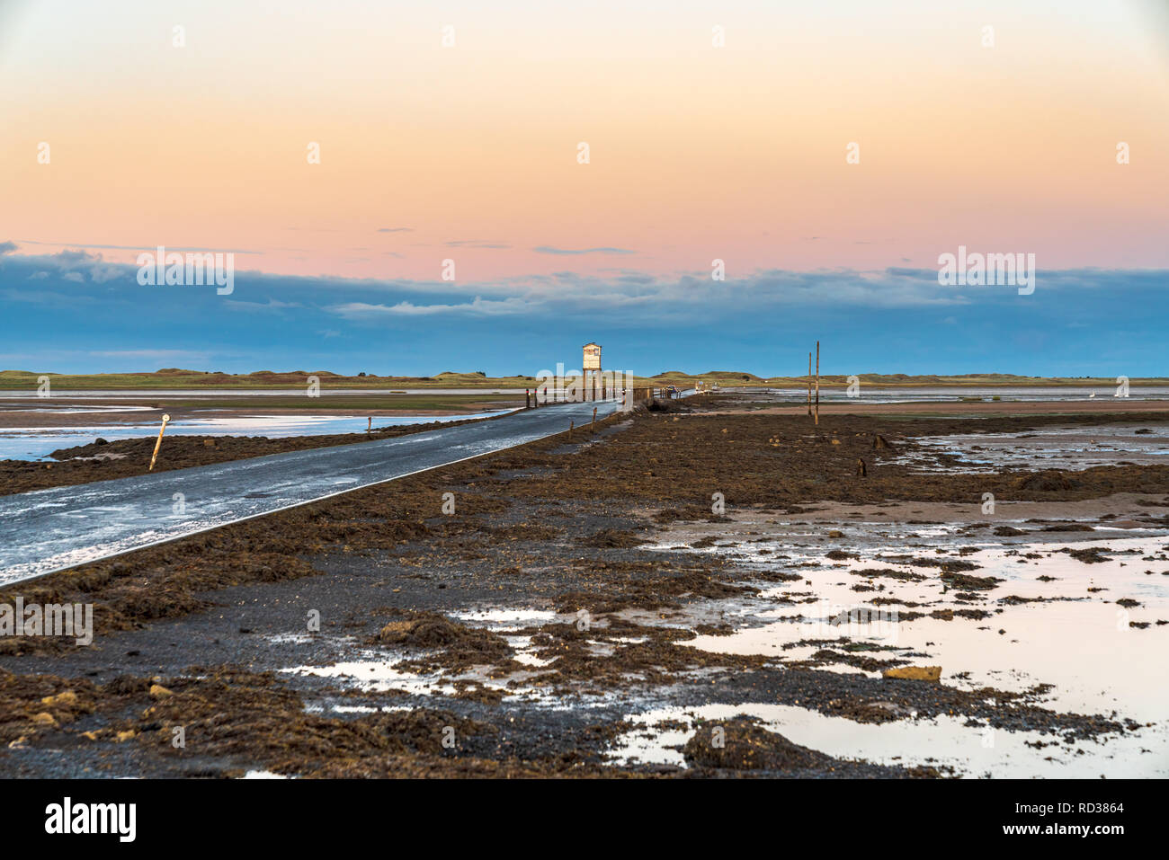Evening sky and low tide on the road  between Beal and Holy Island, Northumberland, England, UK Stock Photo