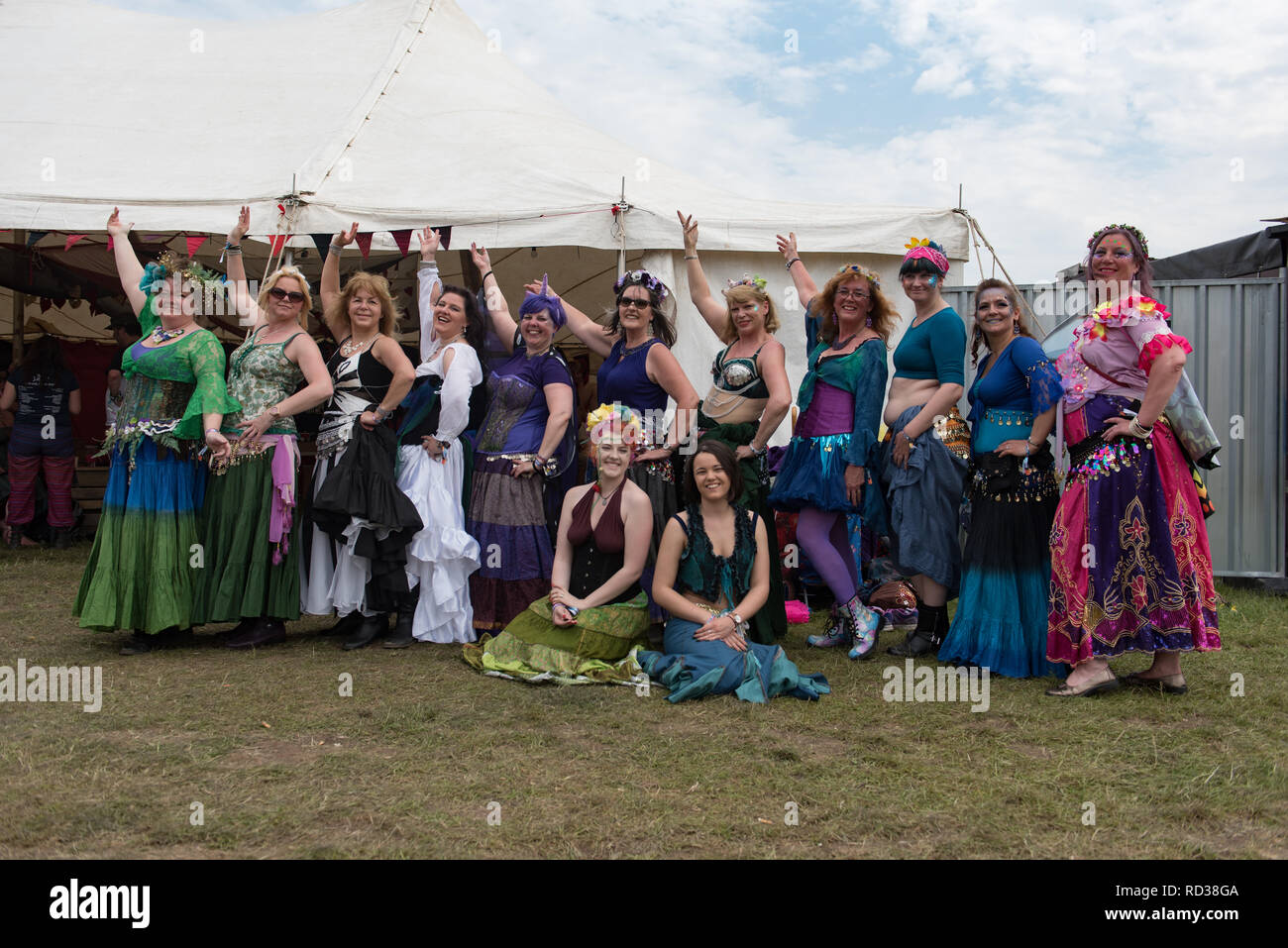 Belly dancers posing outside a marquee at a music festival Stock Photo
