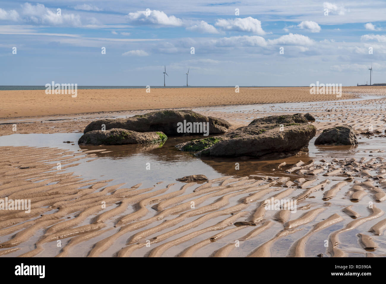 North Sea coast in Cambois, Northumberland, England, UK - the beach with wind turbines in the background Stock Photo