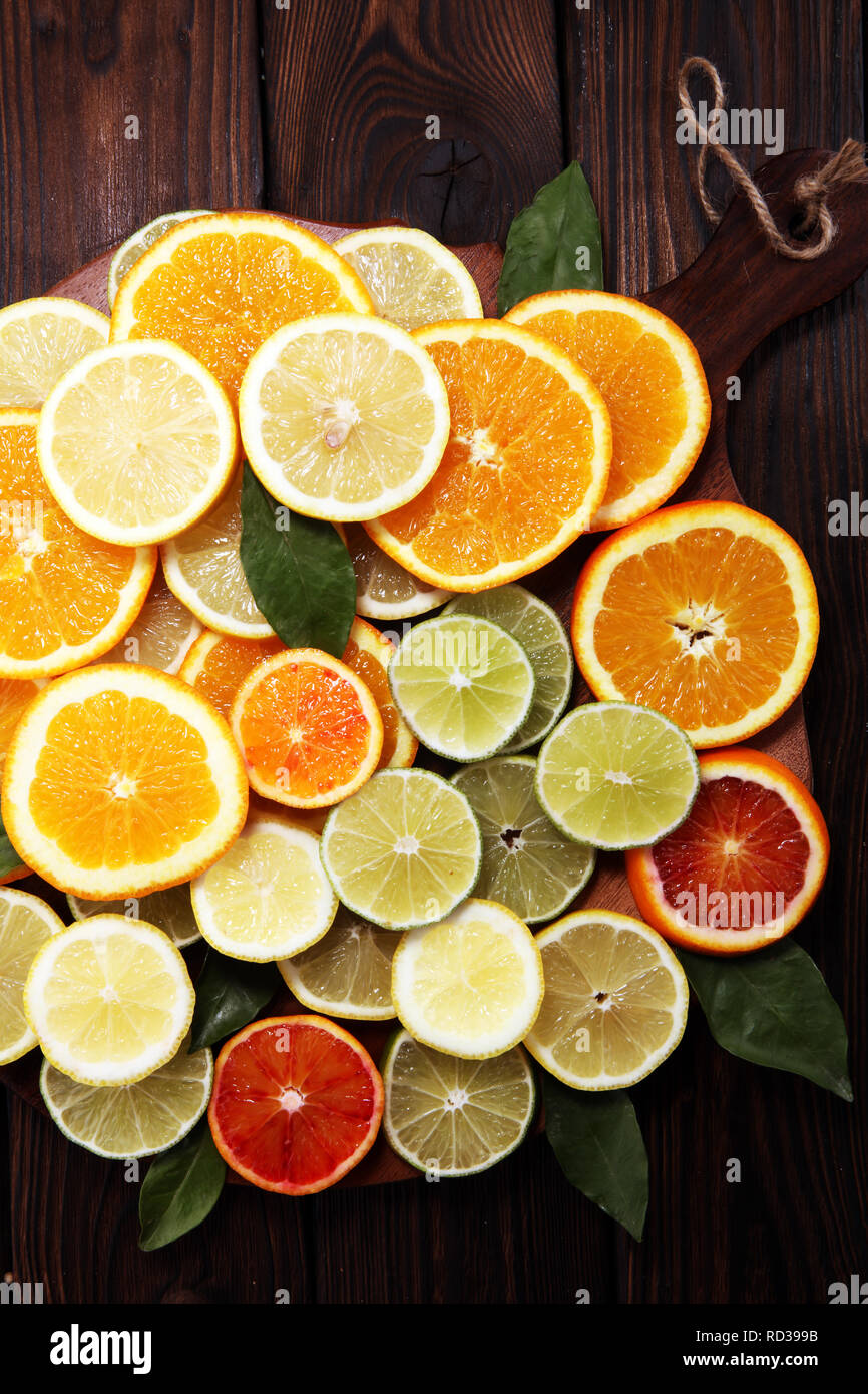 Citrus fruits with orange, lemon, grapefruit and lime on brown