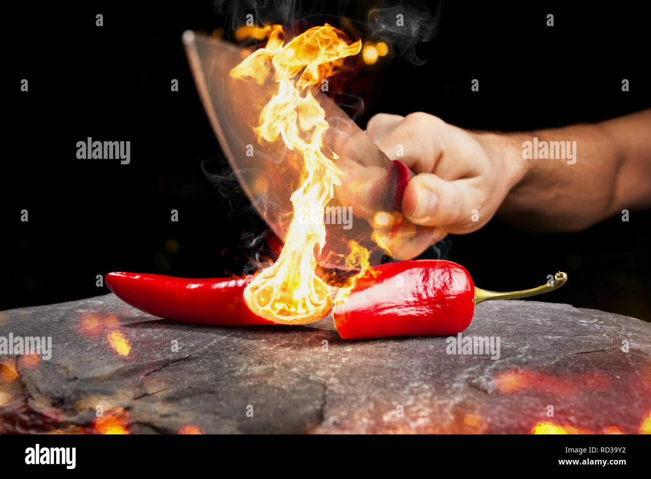 Cut chili pepper burning with an actual flame Stock Photo