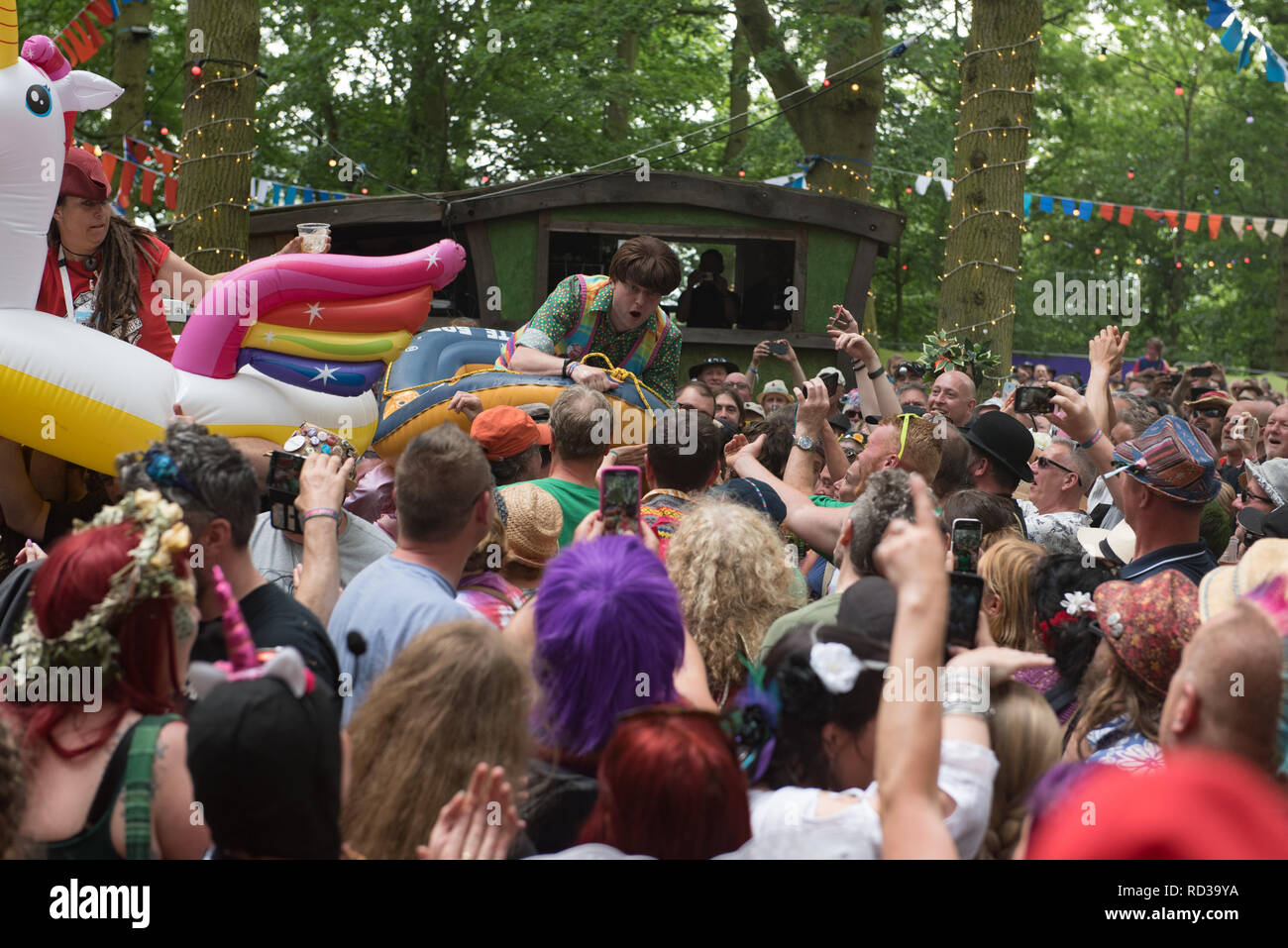 Scott Doonican crowd surfing in a rubber dinghy at the Bearded Theory festival Stock Photo
