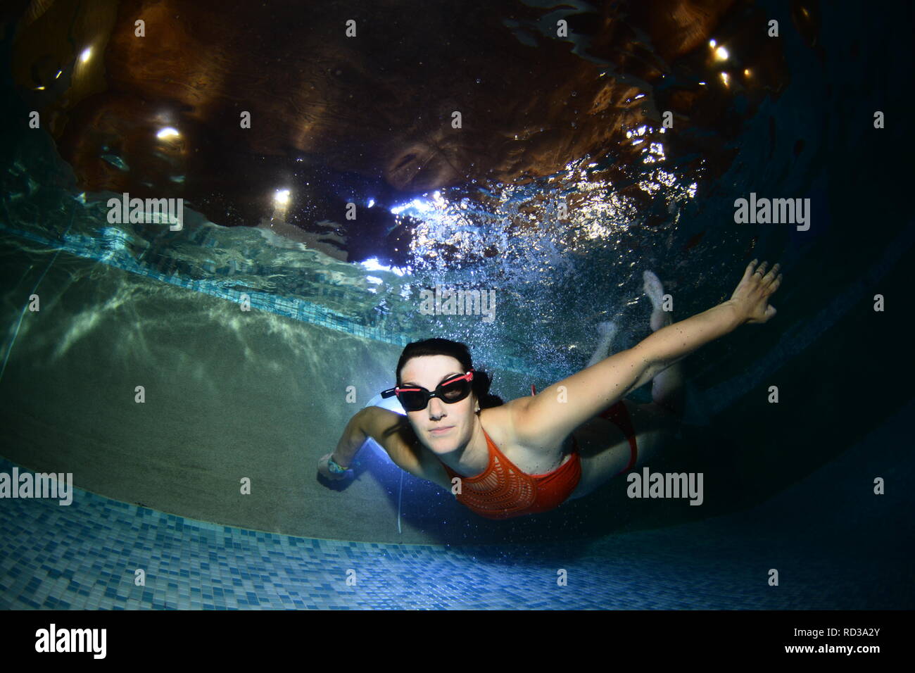 Women swimming underwater in a swimming pool Stock Photo