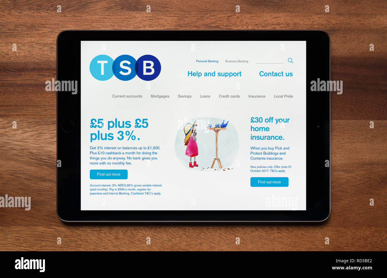 The website of TSB is seen on an iPad tablet, which is resting on a wooden table (Editorial use only). Stock Photo