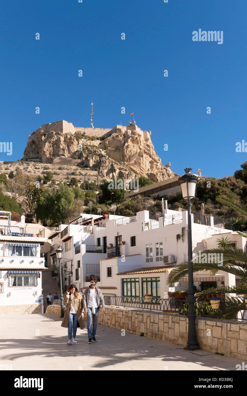 Couple walking through Alicante old town with the castle in the background, Spain, Europe Stock Photo