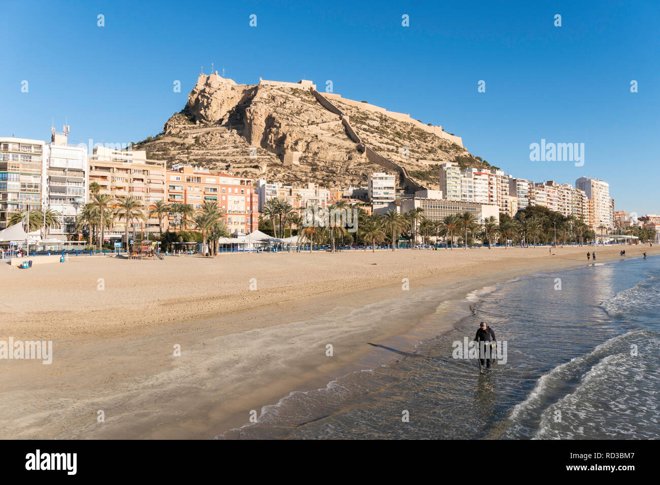 Man using metal detector along the beach in Alicante, Spain, Europe Stock Photo