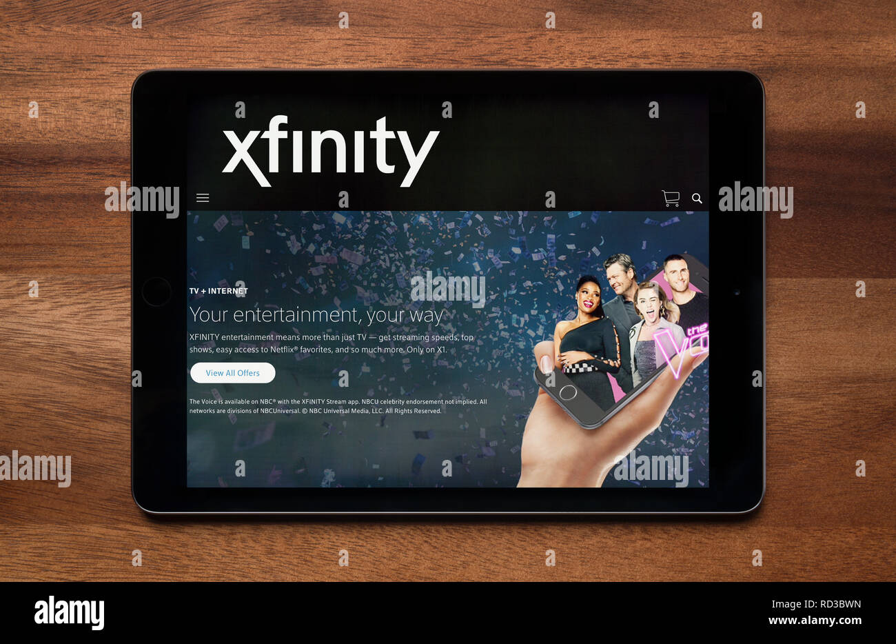 The website of Xfinity is seen on an iPad tablet, which is resting on a  wooden table (Editorial use only Stock Photo - Alamy