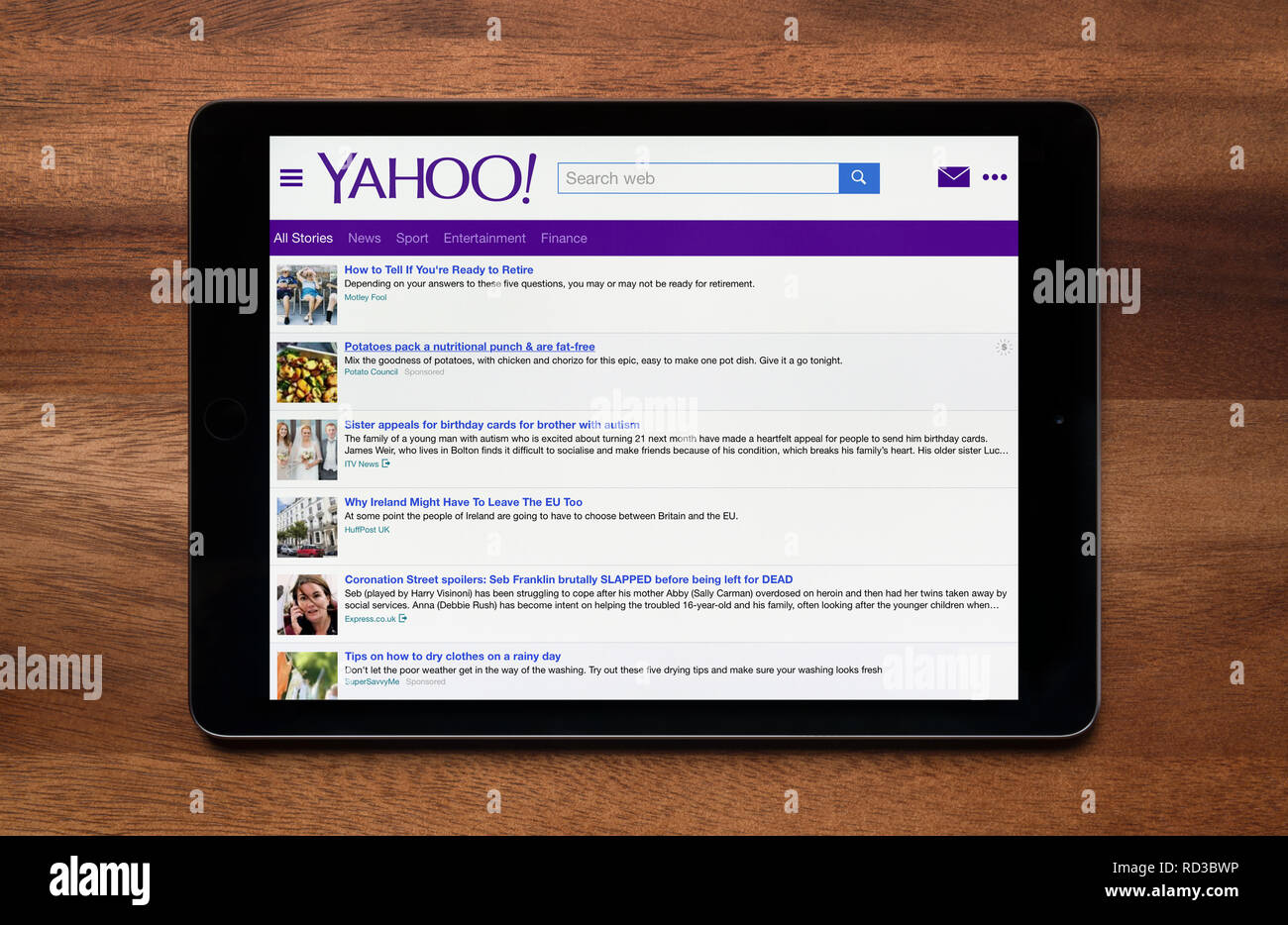The Website Of Yahoo Is Seen On An Ipad Tablet Which Is Resting On A Wooden Table Editorial Use Only Stock Photo Alamy