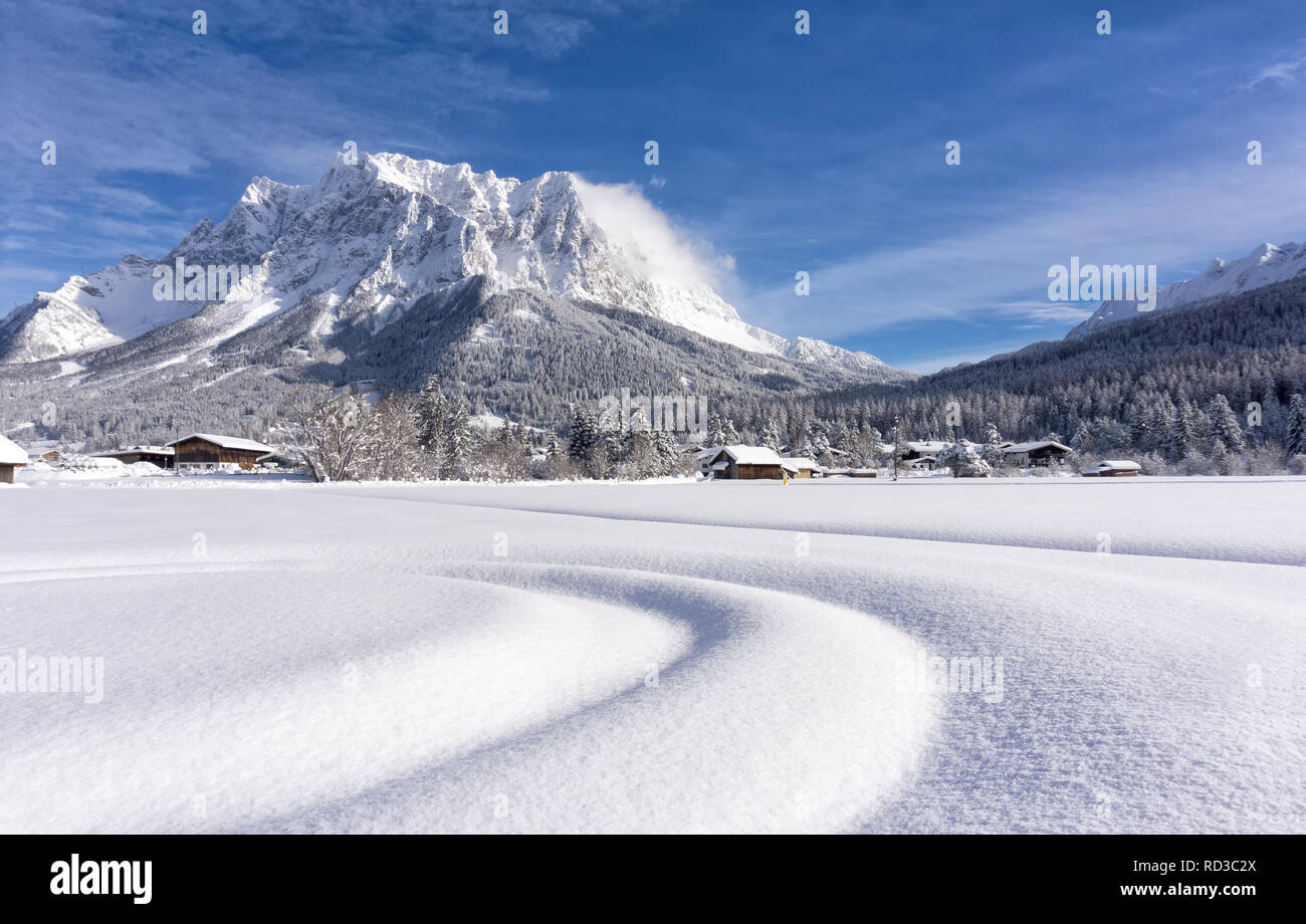 The Zugspitze Massif from the valley of Ehrwald in sunny winter day. Winter mountain landscape. Stock Photo