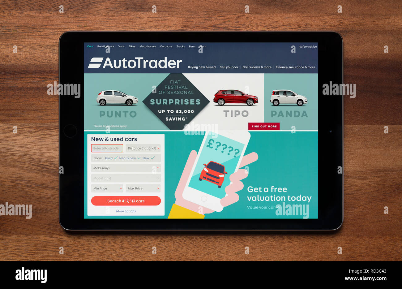 The website of AutoTrader is seen on an iPad tablet, which is resting