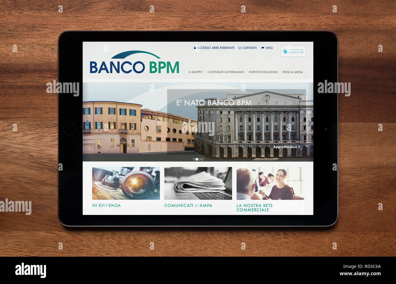 The website of Banco BPM is seen on an iPad tablet, which is resting on a wooden table (Editorial use only). Stock Photo