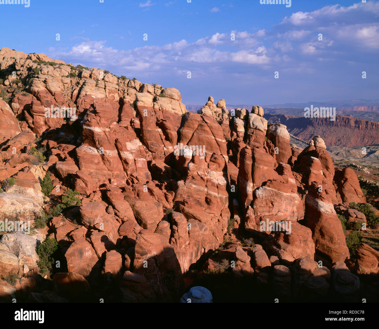 USA, Utah, Arches National Park, Evening light on fins composed of brown Entrada Sandstone beneath a lighter layer of Navajo Sandstone; Fiery Furnace  Stock Photo