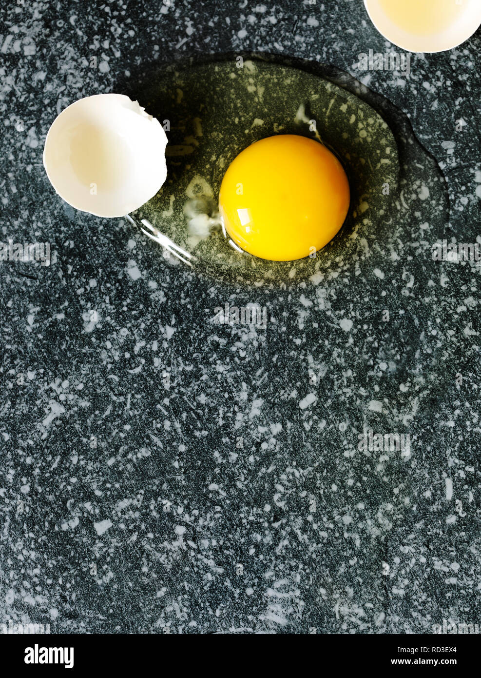 Cracked egg on a stone surface Stock Photo Alamy
