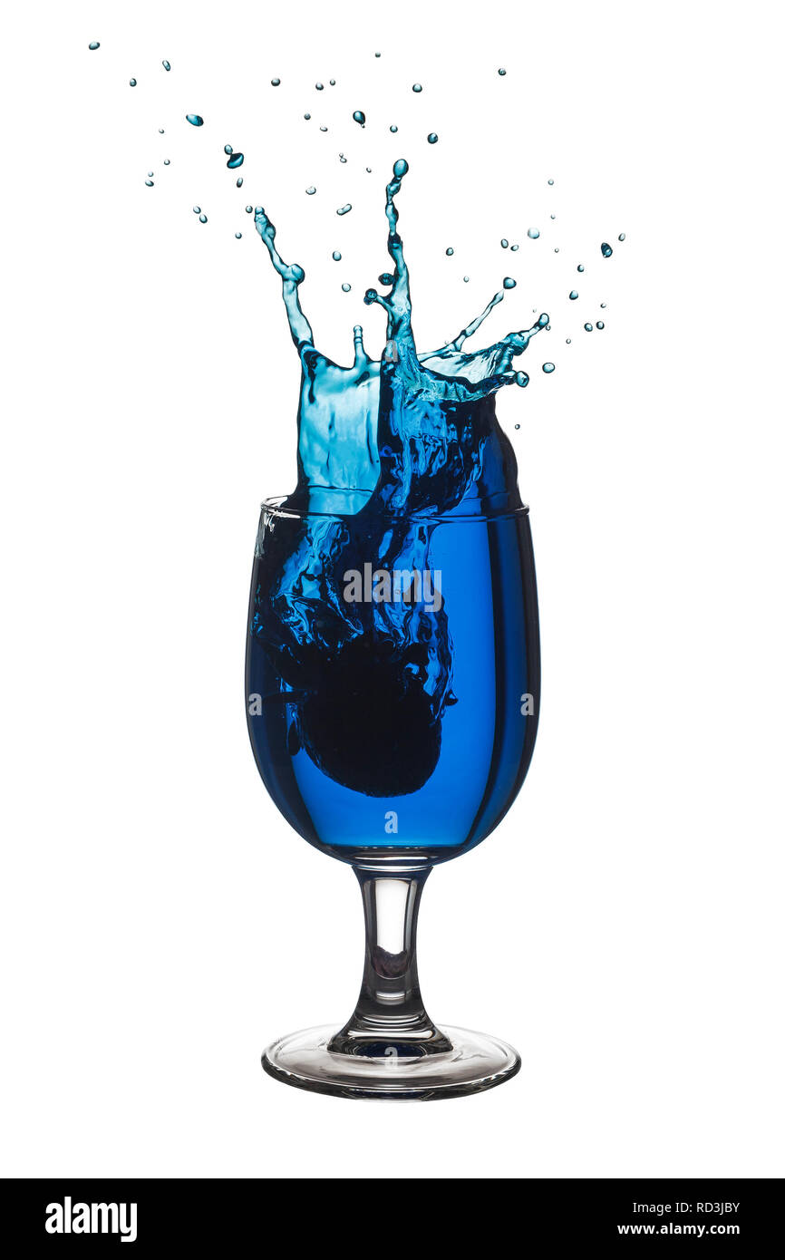 Blue liquid splashing out of a glass Stock Photo