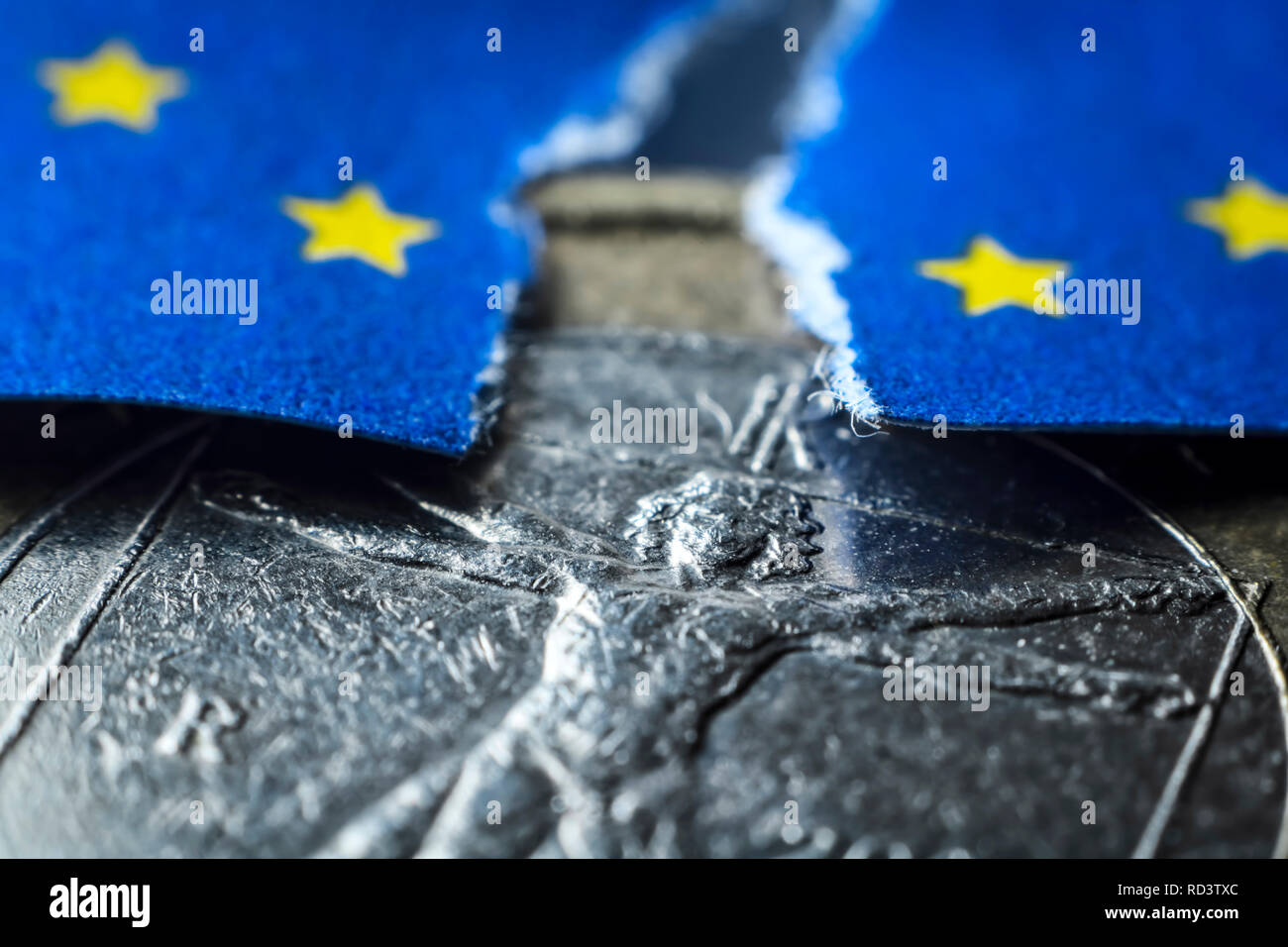Italian eurocoin and torn EU flag, symbolic photo debt crisis in Italy, Italienische Euromünze und angerissene EU-Fahne, Symbolfoto Schuldenkrise in I Stock Photo