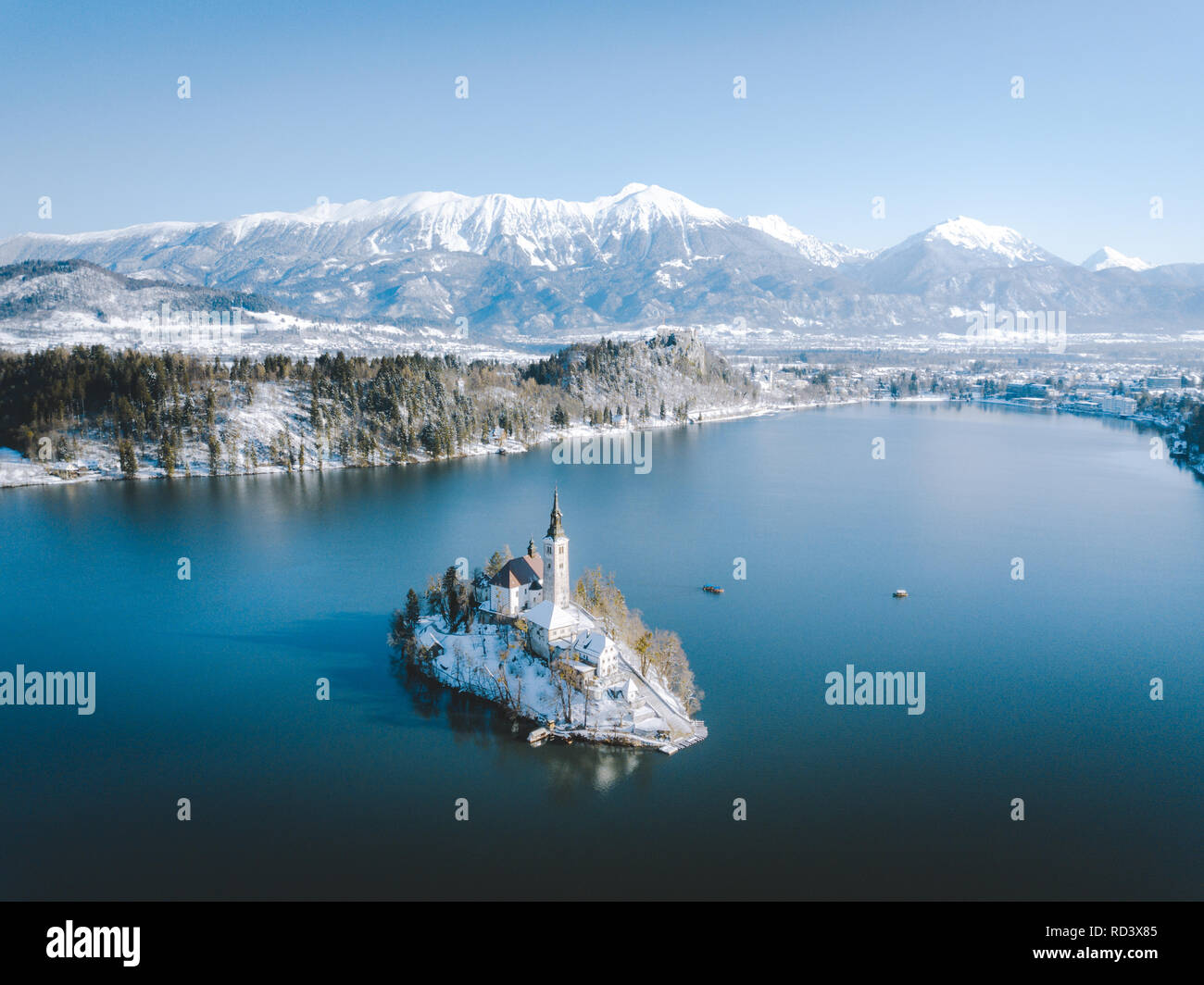 Panoramic view of scenic Lake Bled with famous Bled Island and castle (Blejski grad) in the background on a beautiful sunny day in winter, Slovenia Stock Photo