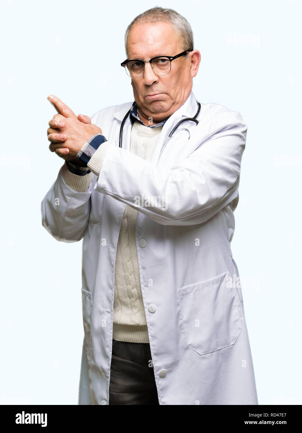 Handsome senior doctor man wearing medical coat Holding symbolic gun ...