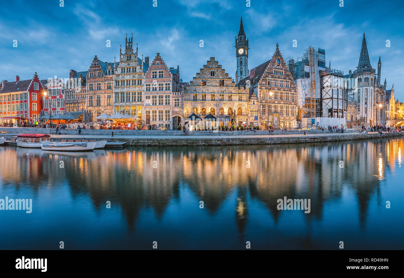 Panoramic view of famous Graslei in the historic city center of Ghent illuminated in beautiful post sunset twilight during blue hour at dusk Stock Photo