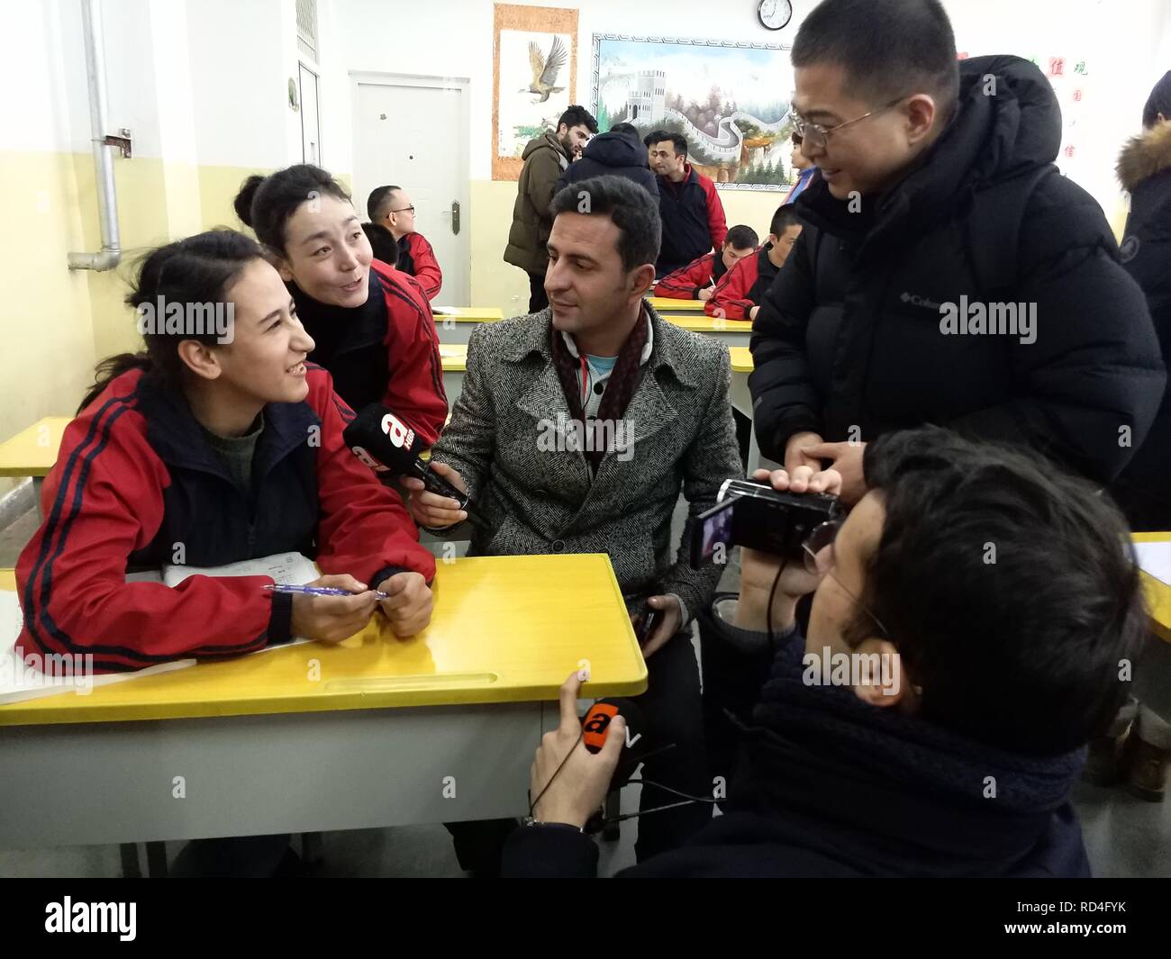 (190117) -- URUMQI, Jan. 17, 2019 (Xinhua) -- Foreign journalists interview students at Kashgar vocational education and training center in Kashgar, northwest China's Xinjiang Uygur Autonomous Region, Jan. 13, 2019. A media group consisting of people from six countries praised the development and stability of Xinjiang after visiting the region. The Silk Road Celebrity China Tour was held from Jan. 9 to 16 in Xinjiang, with 12 media representatives from Egypt, Turkey, Pakistan, Afghanistan, Bangladesh and Sri Lanka visiting locals and a vocational training center. (Xinhua/Yu Tao) Stock Photo
