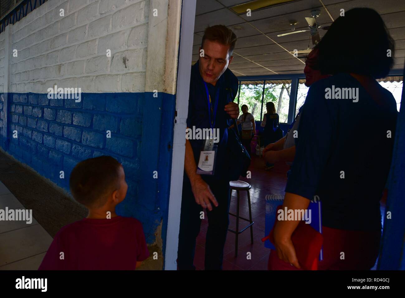 An Electoral Observer from the EU speaks to a kid in the Federico Gonzalez educational complex. The European Union deployed over 80 Observers to the El Salvador electoral process with hopes to 'make an important contribution to this electoral process' Stock Photo