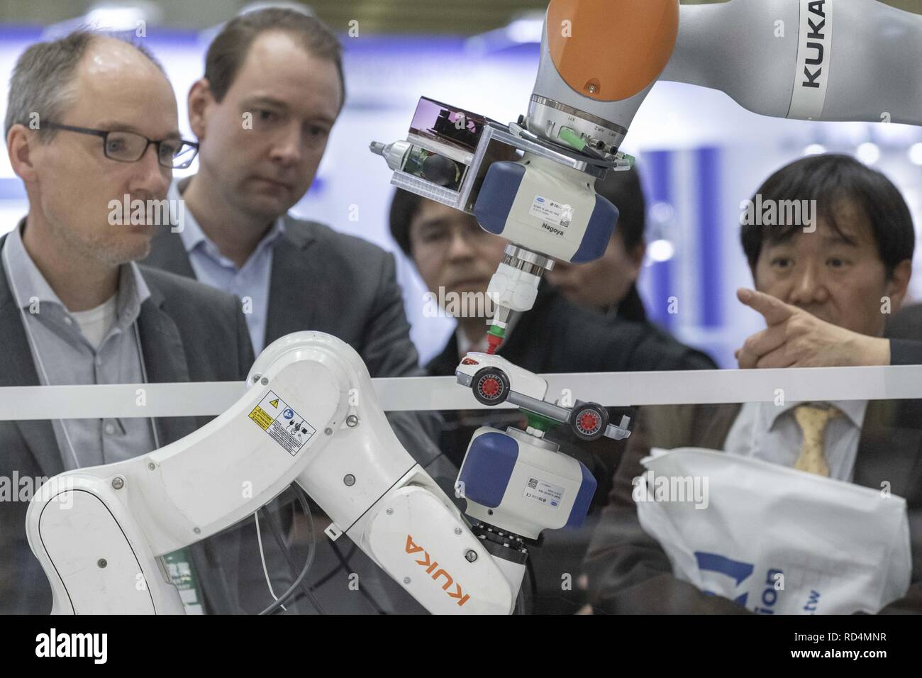 Tokyo, Japan. 17th Jan, 2019. Visitors look at robot arms assembling a toy car during the RoboDEX at Tokyo Big Sight. The 3rd Robot Development and Application Expo (RoboDEX) introduces the latest products and technologies from robot companies which runs from January 16 to 18. Credit: Rodrigo Reyes Marin/ZUMA Wire/Alamy Live News Stock Photo