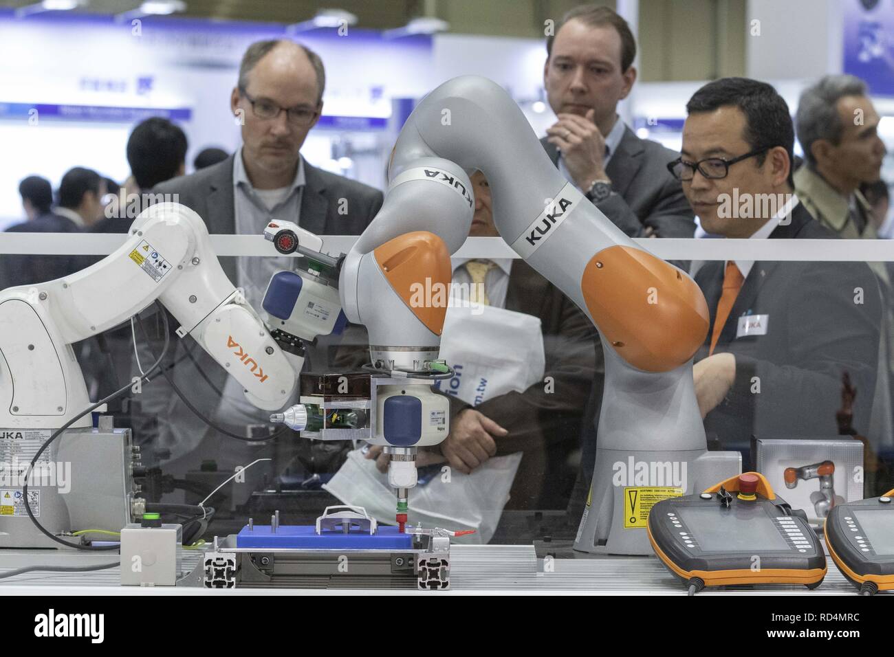 Tokyo, Japan. 17th Jan, 2019. Visitors look at robot arms assembling a toy car during the RoboDEX at Tokyo Big Sight. The 3rd Robot Development and Application Expo (RoboDEX) introduces the latest products and technologies from robot companies which runs from January 16 to 18. Credit: Rodrigo Reyes Marin/ZUMA Wire/Alamy Live News Stock Photo