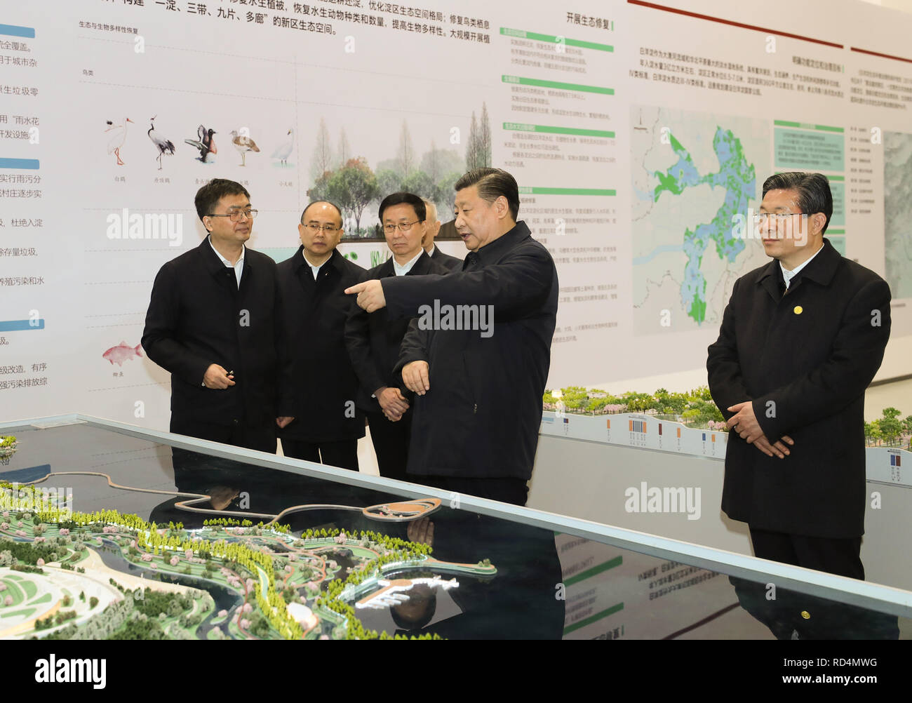 Xiongan New Area, China's Hebei Province. 16th Jan, 2019. Chinese President Xi Jinping, also general secretary of the Communist Party of China (CPC) Central Committee and chairman of the Central Military Commission, listens to the introduction of the general plan, policy system and construction of Xiongan New Area at the Xiongan planning exhibition center during his inspection in Xiongan New Area, north China's Hebei Province, Jan. 16, 2019. Credit: Ju Peng/Xinhua/Alamy Live News Stock Photo