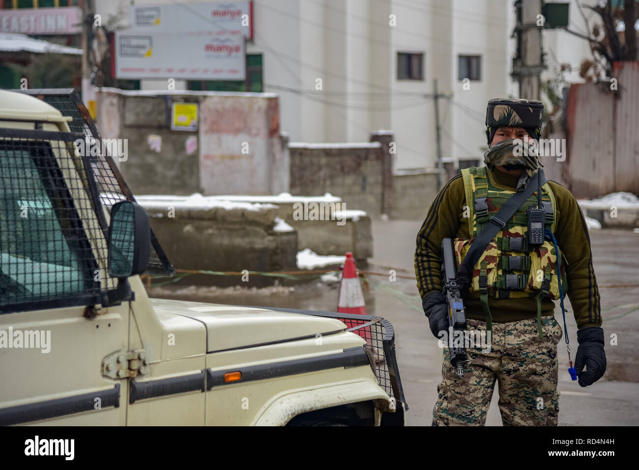 An Indian army-man seen standing on guard near the site of explosion in Srinagar. According to Police, at least five members of government forces were injured on Thursday in a grenade explosion blamed on rebels fighting against Indian rule in Indian-controlled Kashmir's main city. Stock Photo