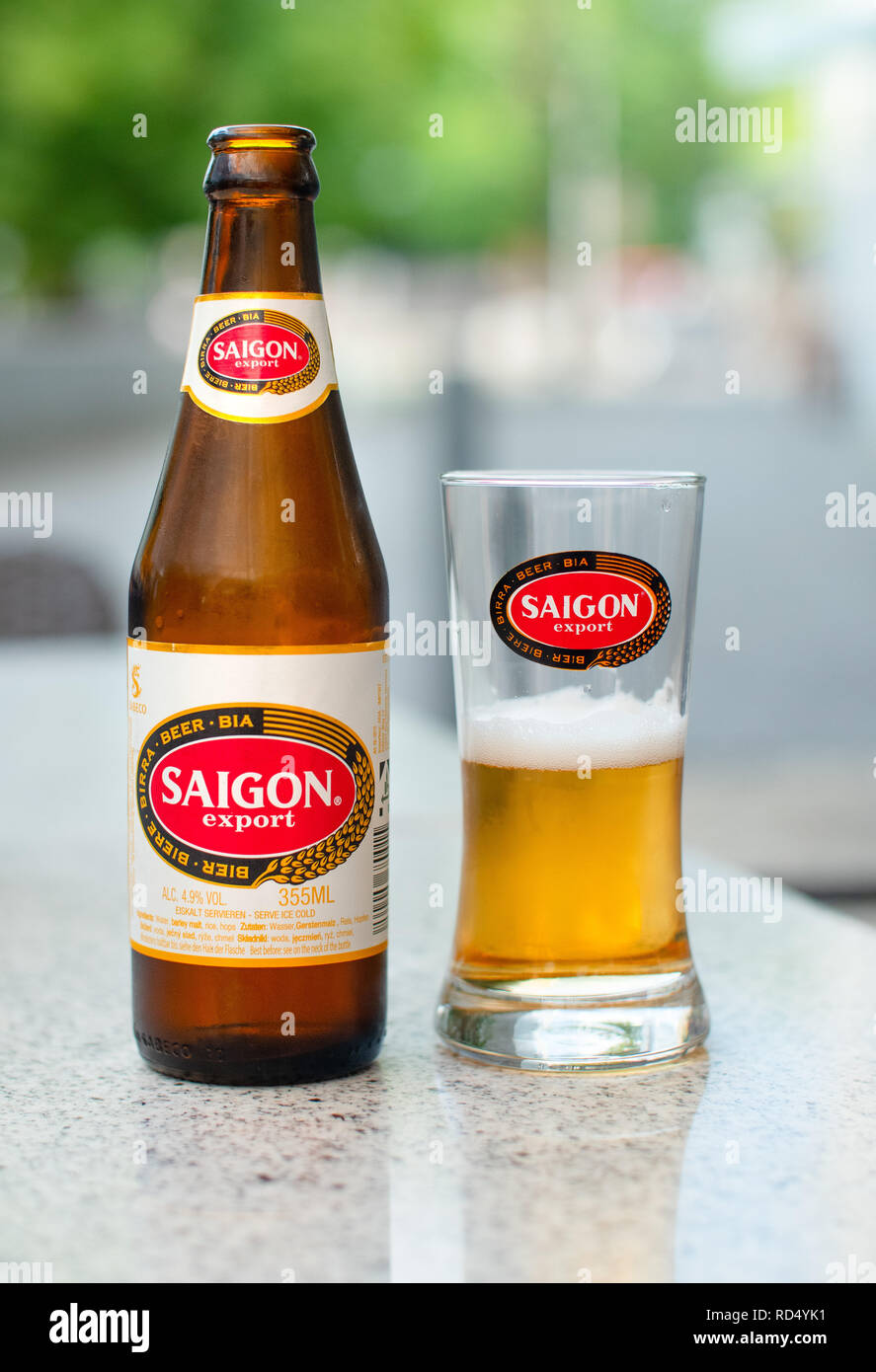 BERLIN, GERMANY - JULY 2018: A Saigon beer bottle and glass on a marble table at a street cafe Stock Photo